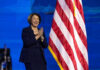 Minnesota’s Dirty Secret: Flawed Prosecution Revealed Person clapping near American flag on stage.