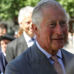 King Charles’ GREEN PUSH at Chelsea Flower Show! elderly man in a gray suit smiling outdoors