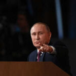 Putin Signals War’s End—Analysts Call TOTAL Deception Person pointing while speaking at a podium