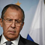 Man in suit with Russian flag backdrop