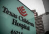 Hospital sign in front of modern office buildings