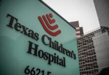 Hospital sign in front of modern office buildings