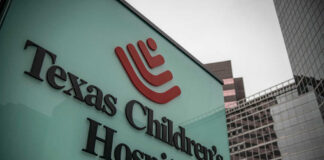 Hospital sign in front of modern office buildings