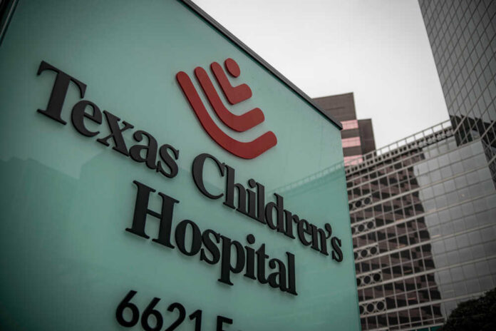 Hospital sign in front of modern office buildings