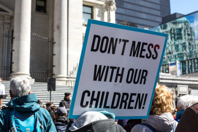Vancouver,,Bc,,Canada,,04.10.2021,A,Sign,Don't,Mess,With,Our Protest sign held by a crowd in an urban square