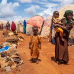 Natural Disasters Push Somalia to the Brink of Famine Children in a makeshift camp on a dry, dusty ground
