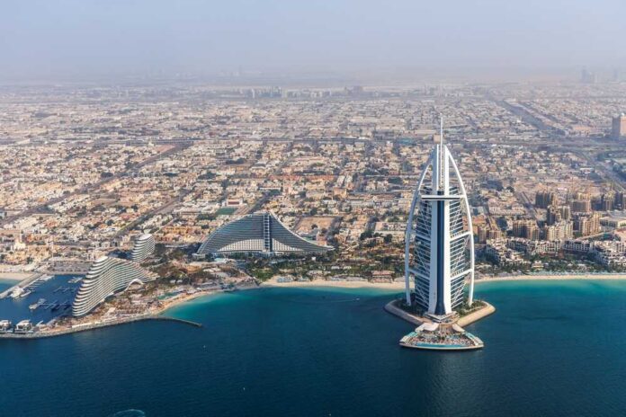 Aerial view of Dubai featuring the Burj Al Arab and surrounding buildings