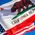 $1 TRILLION Wealth Exodus — California Panics California Republic flag waving alongside the American flag against a blue sky