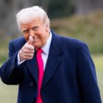 TRUMP Allies With Brazil: Washington’s New Power Shift A man in a dark coat and pink tie giving a thumbs up outdoors