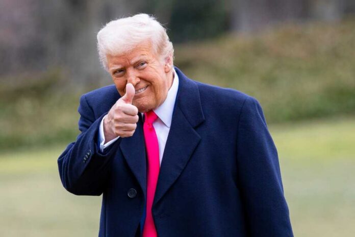 Washington,,February,22,,2025:,President,Donald,Trump,Gives,A A man in a dark coat and pink tie giving a thumbs up outdoors