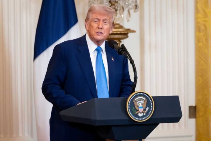 shutterstock_2590278927.jpg Donald Trump delivering a speech at a podium in the White House