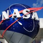 Volunteers Rewrite Cosmic Population Maps NASA logo displayed on a large globe structure