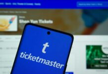Congress Takes Aim at Ticketmaster Monopoly Mobile phone displaying the Ticketmaster app with event details in the background