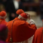 Cardinals in red robes participating in a religious ceremony
