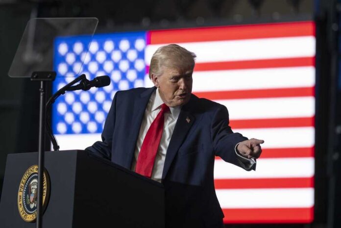Clive,,Iowa,,United,States,,January,27,,2026,,President A man in a suit gestures while speaking at a podium with an American flag in the background