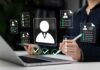 Recruiter reviewing digital resumes on laptop and tablet