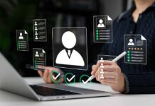 Resume Robots: Are Humans Being Shut Out? Recruiter reviewing digital resumes on laptop and tablet