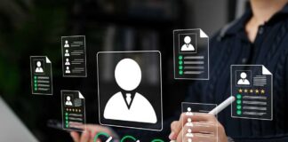 Recruiter reviewing digital resumes on laptop and tablet