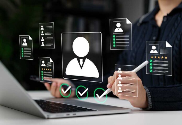 Candidate,Screening,And,Resume,Evaluation,Concept.,Woman,Using,Laptop,With Recruiter reviewing digital resumes on laptop and tablet
