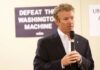 A man speaking into a microphone at a campaign event