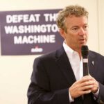 A man speaking into a microphone at a campaign event