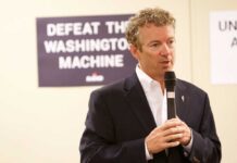 A man speaking into a microphone at a campaign event