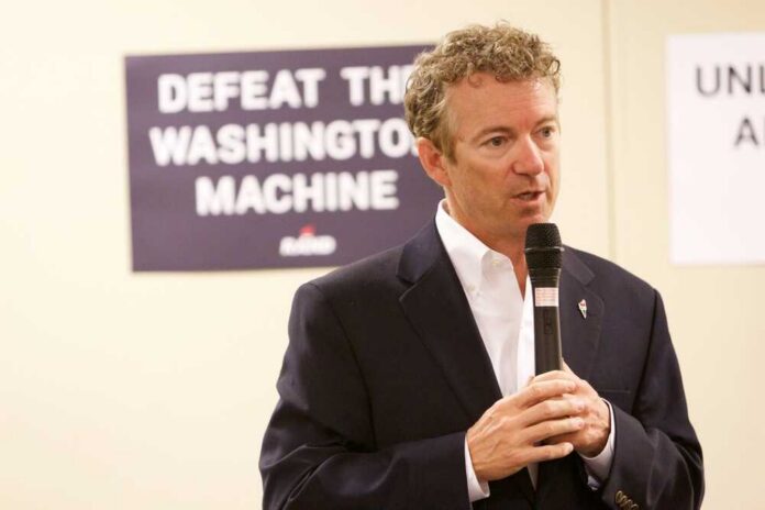 A man speaking into a microphone at a campaign event