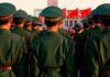 China’s SHOCKING Iran Arms Plot Exposed Mid-Summit Group of uniformed soldiers standing in formation during a ceremony
