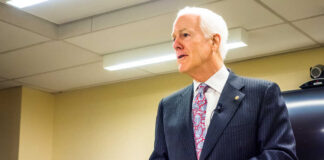 A man in a suit delivering a speech in a conference room