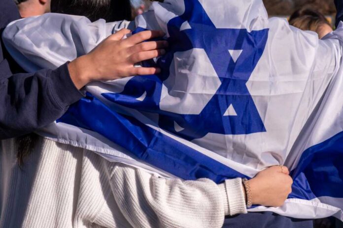 Washington,,D.c.,,Usa,November,14,,2023:,Pro-israel,Supporters,Stand,,Draped People holding an Israeli flag together, showcasing unity and cultural pride