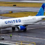 United Airlines Airbus A319 taxiing on a wet airport tarmac