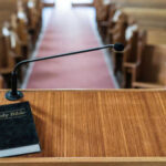 Israel-Linked Ads Target Worshippers Bible and microphone on a church pulpit