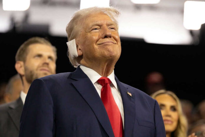 donald-trump2497649801jpg Smiling older man in a suit with a red tie at an indoor event