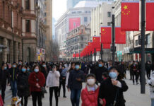 G7 Without China? Critics Cry “Mistake” — Trump Allies Say It’s the Point Crowded street with people wearing masks and flags