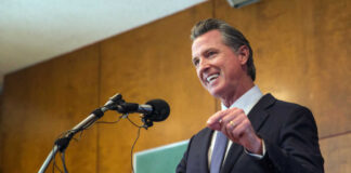Man speaking at podium with microphone