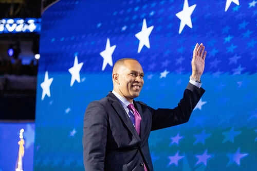 Person waving in front of a starry blue background