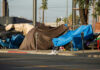 Street tents and tarps along a sidewalk