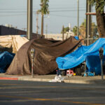 60% Homelessness Jump Tied to Asylum Wave Street tents and tarps along a sidewalk