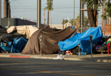 Street tents and tarps along a sidewalk