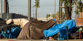 Street tents and tarps along a sidewalk
