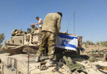 Israel’s Litani Push: Buffer Or Land Grab? Soldiers on tank with Israeli flag in open field