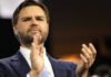 Iran Playbook: Real Deal Or PR Mirage? Man in suit clapping at an event