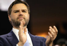 Iran Playbook: Real Deal Or PR Mirage? Man in suit clapping at an event