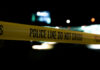 Baltimore’s Bar Row Becomes War Zone Yellow police line tape at night with blurred city lights