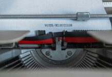 Typewriter typing the words VOTE/ELECTION on a sheet of paper