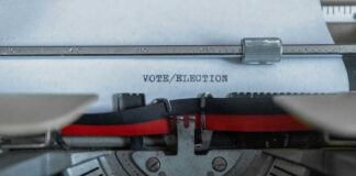 Typewriter typing the words VOTE/ELECTION on a sheet of paper