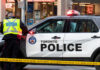 Consulate Gunfire Trail — Toronto Cop Killed Police officers in high-visibility jackets with radios.