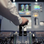 License Lie Rocks Air Canada Pilot's hand operating the throttle in an aircraft cockpit