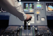 License Lie Rocks Air Canada Pilot's hand operating the throttle in an aircraft cockpit