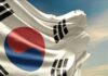 Trillion-Dollar Chip Gamble Sparks Panic Waving South Korean flag with a blue sky background